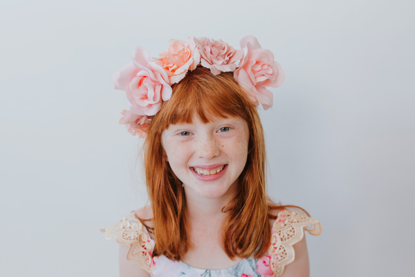 family photography session in studio. Little girl in flower crown